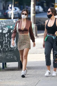 Emily Ratajkowski in mini skirt out for a walk with a friend in New York