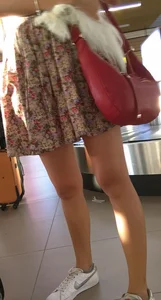 Girl in Flowery Dress with Sexy Thin Legs and a Cute Dog in Her Hands Airport Candid