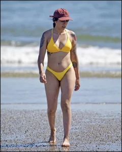 Sexy tattooed beach brunette with a great ass in yellow thong bikini