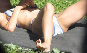 Sunbathing girl's closeups in a park