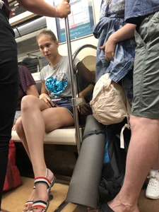 Tall Candid Teen Girl in Denim Shorts And Sandals Sitting in the Subway Train, Then Walking Down the Station