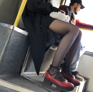 Amazing legs in black pantyhose in a public bus