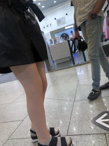 Pale Legs of a Slim Teen at a Mall Gallery
