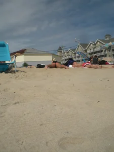 Milf laying out on a beach in Maine in her little thong