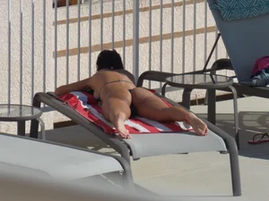 Hot milf sunbathing in a thong by pool and swimming