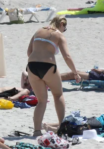 Big boobed thick blonde on the beach in a bikini