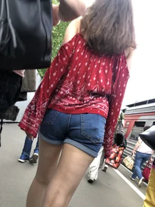Very hot candid girl in denim shorts walking down the train platform