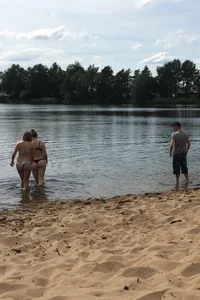 Big boobed babe at the lake in a black thong with blonde friend
