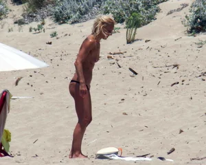 Small boobed topless milf on the beach