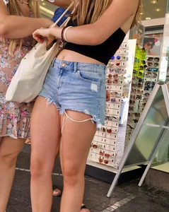 Awesome pics of a candid girl in a top and fringed shorts street creepshots
