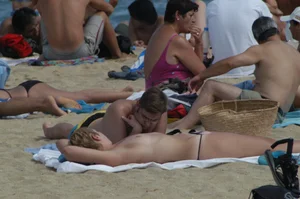 Topless girls on a beach in Barcelona