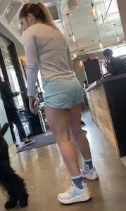 Cute little blue shorts sipping on a latte (VPL and a pokie!)
