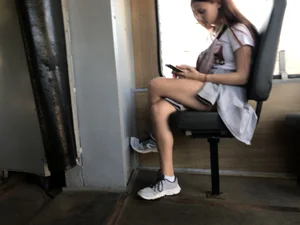 A Cute And Skinny Teen Candid Girl in Shorts Sitting With Crossed Legs in a Public Bus Creepshots Series
