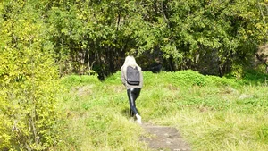 Teen Blonde in Leather Leggings Walking Down a Road