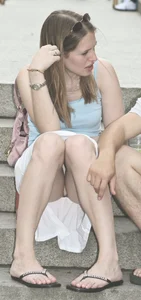 Girl in a Skirt Sitting on the Steps of the Stairs Flashing White Panties