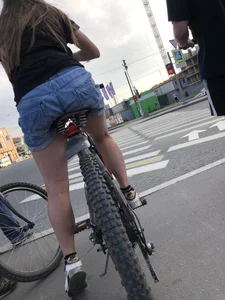 Girl in denim shorts on a bike street pics