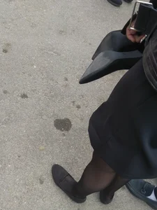Legs and Feet of a Teen Girl in Black Pantyhose and Flats Street Photo