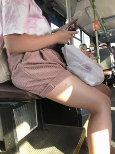 Young Girl in Sandals and Shorts in a Public Bus
