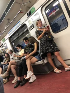 Hot Girl With Gorgeous Legs in Jean Shorts And Sneakers Sitting in a Subway Train With Crossed Legs - Touching And Swinging Her Legs