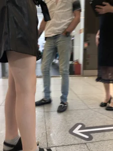 Pale Legs of a Slim Teen at a Mall Gallery