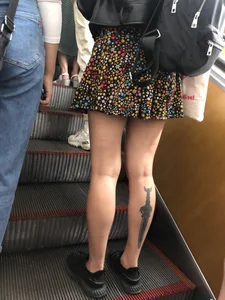 Candid Girl in a Skirt With a Tattoo on Her Calf Subway Escalator Creepshots Gallery