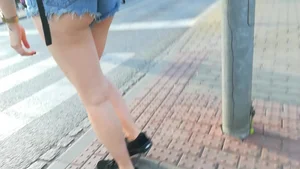 Girl walking in denim shorts showing some of her ass cheeks