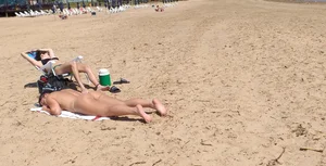 Girl laying out getting sun in a white thong bikini