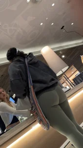 Sexy bubble butt in tight green leggings at the mall
