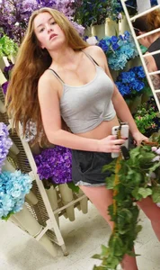Very cute teen in a top and shorts at the flower shop