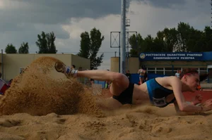 Sexy athletic girl wearing a top and mini shorts (spandex) long distance jumber in sand creepshots