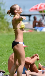Sexy blonde girl in the park playing volleyball in her skimpy bikini