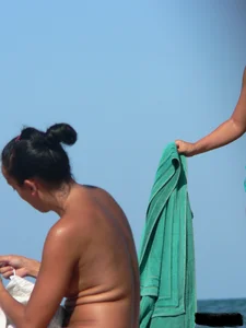 Bunch of sexy babes on the beach topless and in thong bikinis