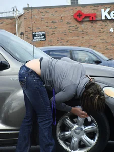 Girl cleaning her car in jeans and showing some cheetah print underwear