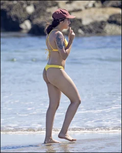 Sexy tattooed beach brunette with a great ass in yellow thong bikini