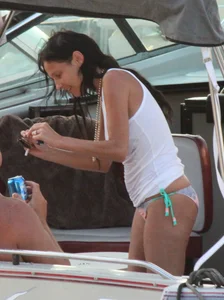 Bikini babe on a boat with a wet see through white shirt showing her tits