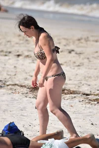 Brunette on the beach in a cheetah print bikini