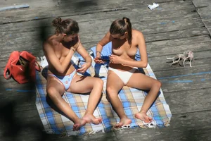Two teens stripping and going topless to tan
