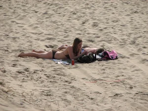 Topless beach girl with nice titties with her friend in a bikini