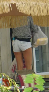 Girl next door teen neighbor bringing in groceries in short jean shorts