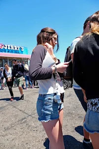 Cute girl walking in short jean shorts