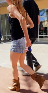 Cute girl with glasses in USA shorts showing her cheeks