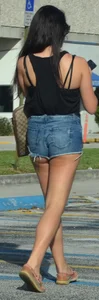 Brunette in short denim shorts showing a little cheek