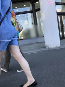 Girl in a Blue Dress With Pale Legs Walking Down the Street - Strong Wind Making Her Panty Line Visible