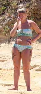 Tattooed thick blonde babe in a bikini
