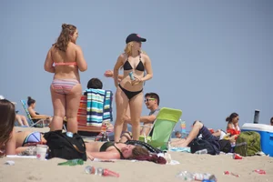 Two thick white girls in bikinis on the beach with big asses