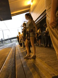 Cute Teen in Shorts on the Tram Stop