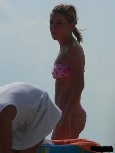A bunch of hot babes on the beach in thong bikinis