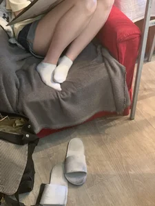 Teen Student Artist in Shorts And White Socks Curled Up in the Armchair - Legs Closeup