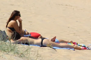 Thick and sexy friends out on the beach in shorts and bikinis
