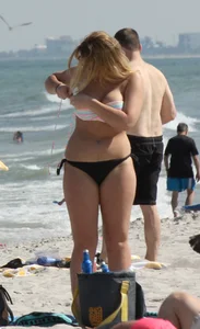 Big boobed thick blonde on the beach in a bikini